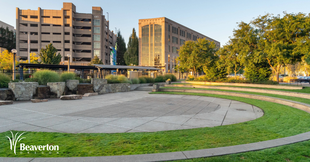 The Beaverton Building (City Hall) viewed from across a small grass and cement amphiteater.